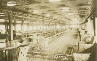 Sepia-toned photo postcard depicting the passenger lounge inside the steamship Noronic. The bac ...