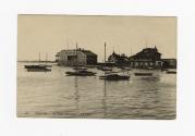 Sepia-toned photo postcard depicting boats floating on Lake Ontario with buildings in the backg ...