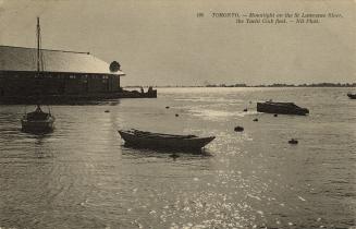 Black-white photo postcard depicting boats floating on the St. Lawrence river with the shore in ...