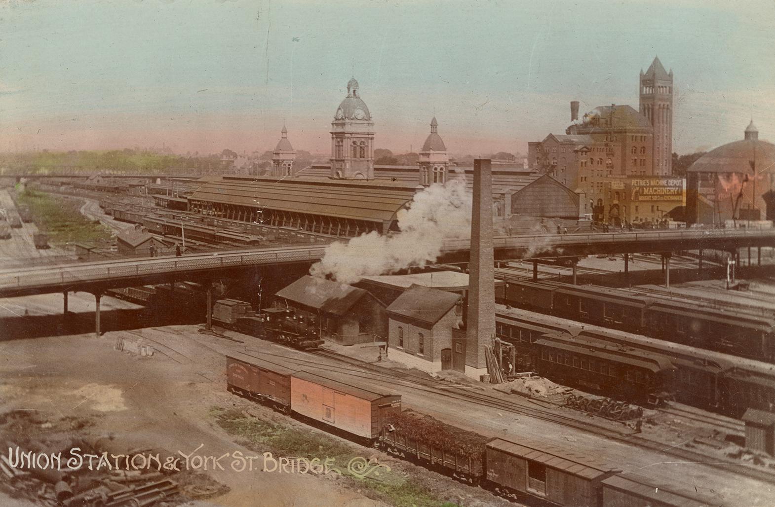 Colour photo postcard depicting an aerial view of trains and a bridge, slightly above and adjac ...