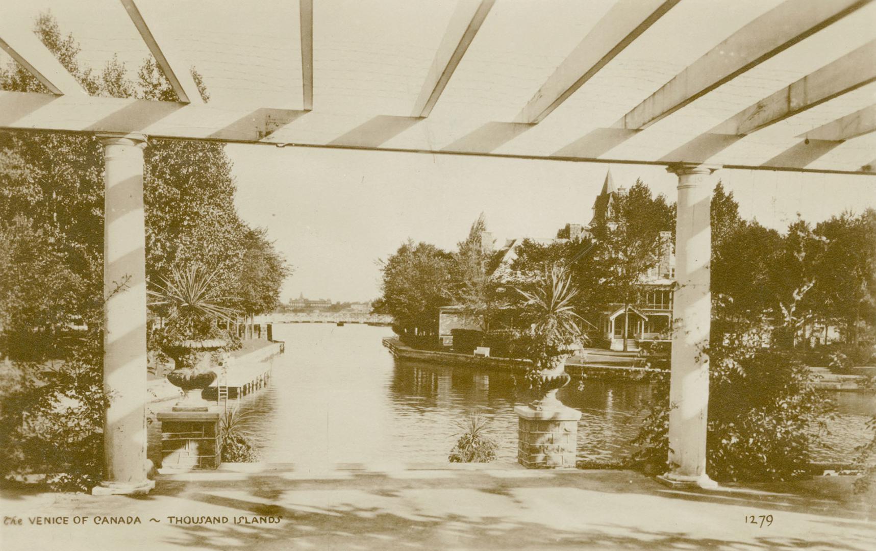 Sepia toned picture of a view of a waterway, taken from the terrace of a summer home.