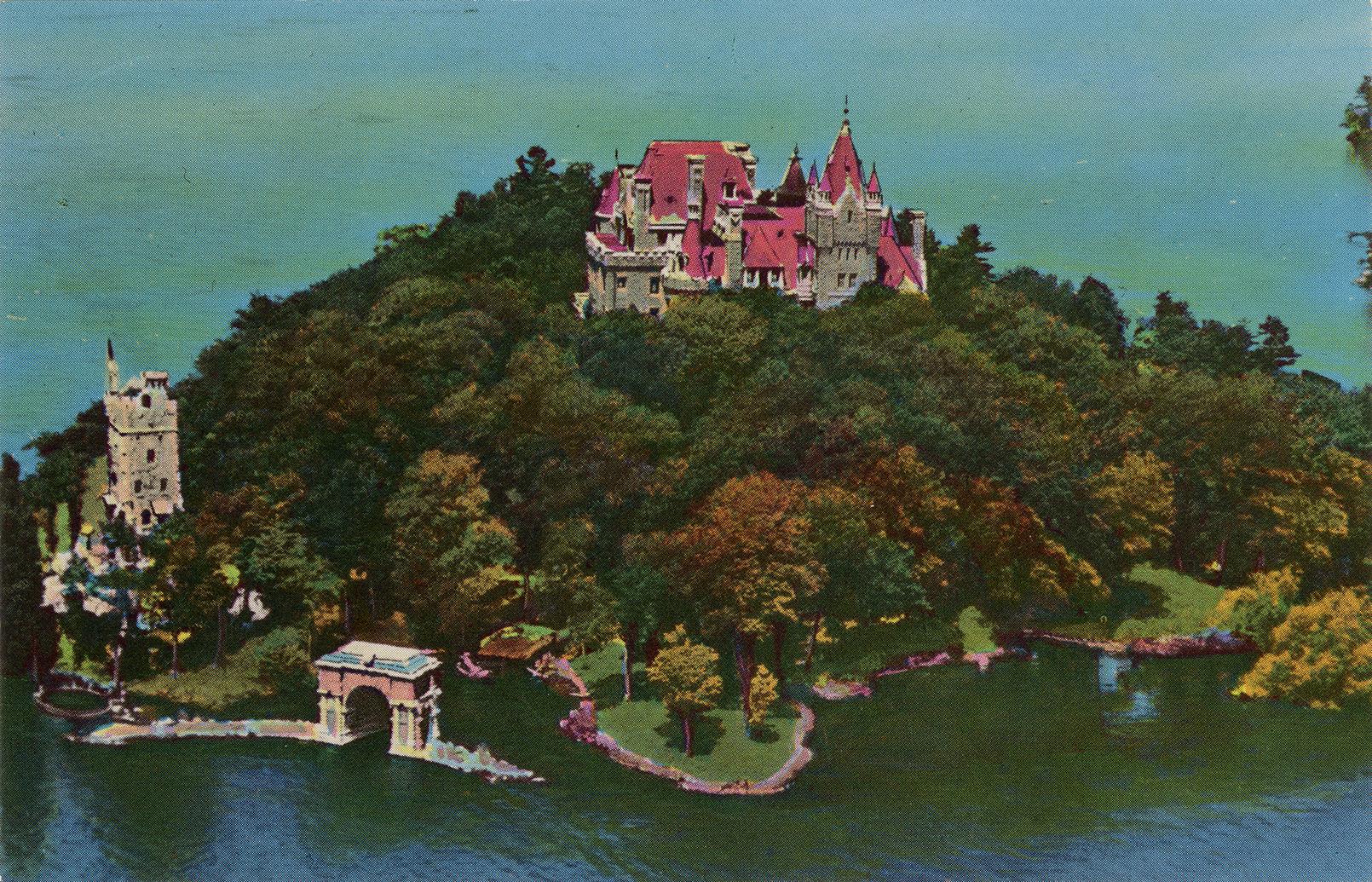 Color photograph of a aerial view of large, stone castle on an island in the middle of a waterw ...