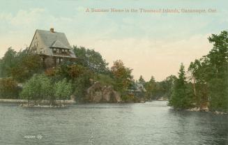 Colorized photograph of large home on an island in the middle of a body of water.