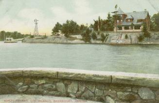 Colorized photograph of river with a large house on an island, taken from the terrace if anothe ...