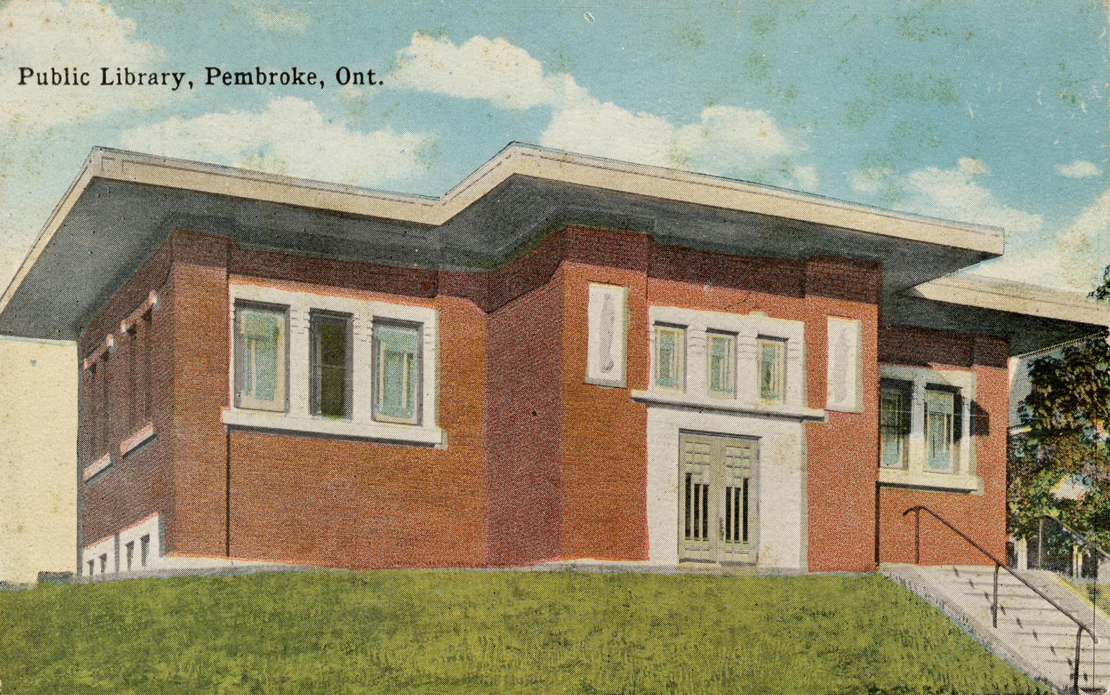 Picture of a one storey library building set on a slight hill.