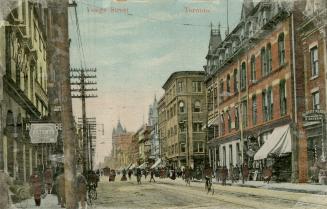 Colour photo postcard depicting a view of Yonge Street looking north from Melinda Street with h ...
