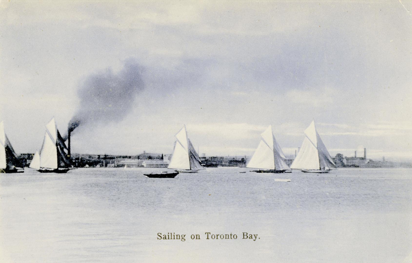 Black and white photograph of sailboats in a harbour.
