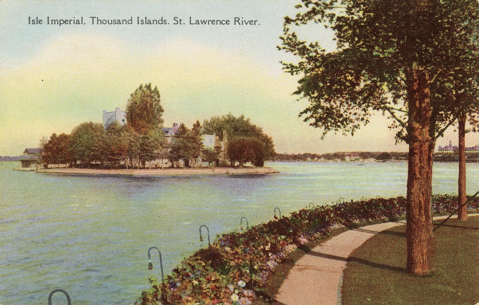 Colorized photograph of a house on an island at the edge of a wide river. 