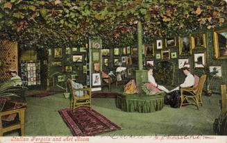 Colorized photograph of a two woman sitting in a green room with pictures all over the room.