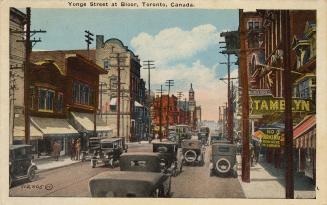 Colour postcard depicting a view of Yonge Street with many shops, cars, a streetcar, and pedest ...