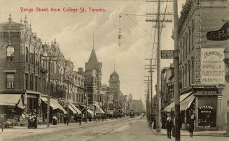 Black and white photo postcard depicting a view of Yonge Street looking south, with many shops  ...