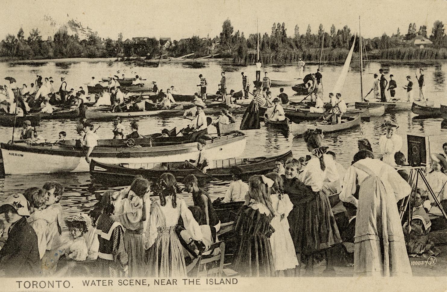 Black and white photograph of crowds of people in row and sail boats with even more people watc ...