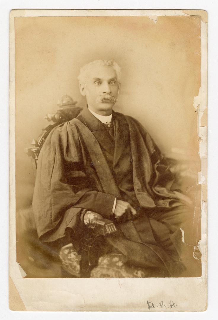 Black and white photograph of Anderson Ruffin Abbott seated, in academic robes