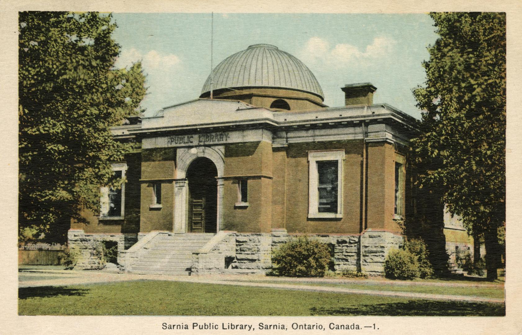 Picture of a brick and stone one storey library building with dome. 