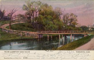 Colorized photograph of a circular wooden bridge running over a stream