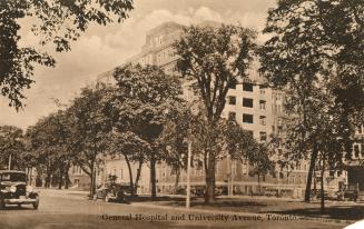 Sepia tones photograph of a huge blockish building with trees on the street in front of it.