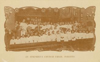 Black and white photograph of a large male choir in robes posing in the interior of a church na ...