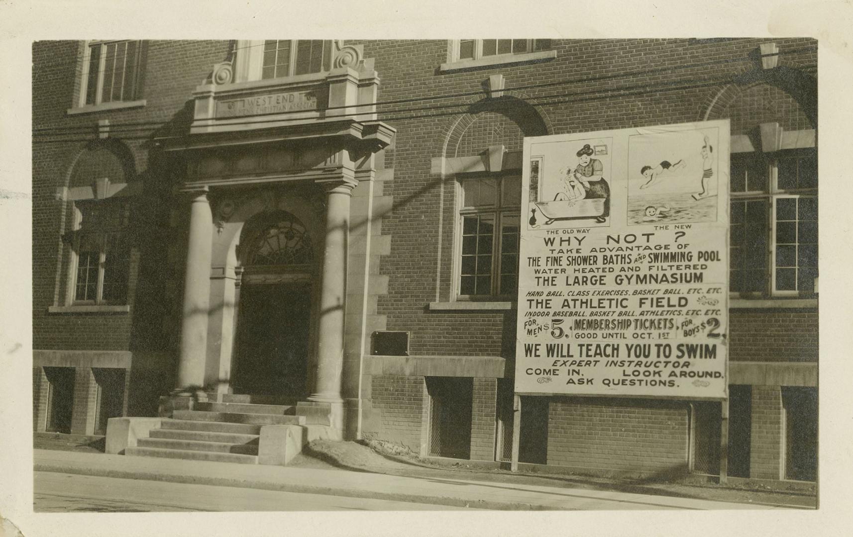 Black and white photograph of a front doorway to a large brick building.