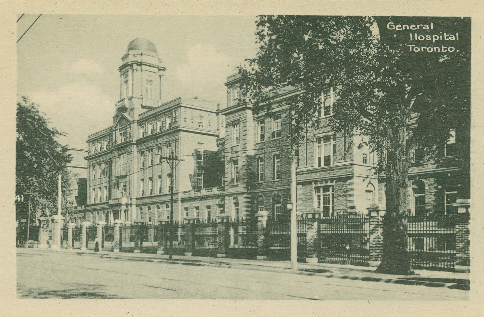 Black and white photograph of a large public building with a cupola.