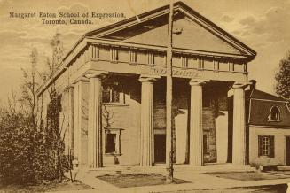 Sepia toned photograph of a very large building with four doric pillars in front of it.