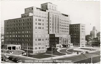 Black and white photo postcard depicting the exterior north-west facade of a hospital with two  ...