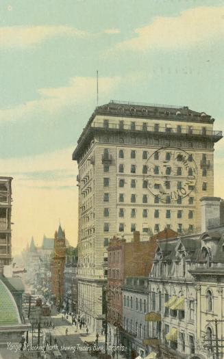 Colorized photograph of a city street with a skyscraper on the right hand side.