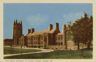 Colorized photograph of a huge, Gothic Revival style building with a clock tower.