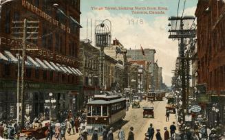 Colorized photograph of a city street with tall office buildings and skyscrapers on either side ...