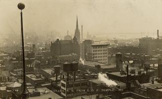 Black and white aerial photograph of a large city.