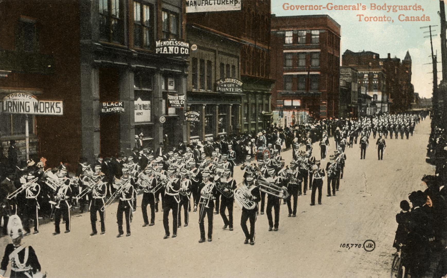 Colorized photograph of men in military uniforms parading on a city street playing musical inst ...