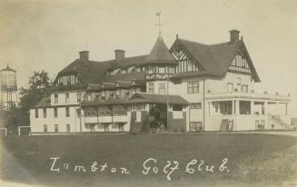 Black and white photograph of a large mock-Tudor building.