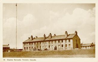 Sepia toned photograph of a two-story wooden structure.