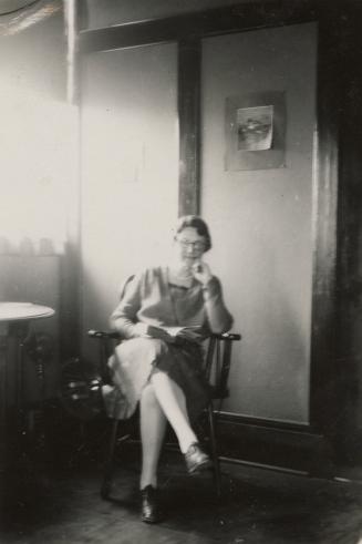 Picture of woman reading a book in a library. 