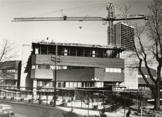 Picture of construction of coop apartment tower on top of library building. 