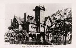 Black and white photo postcard depicting the exterior of a home with arches on its front patio  ...