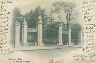 Black and white photograph of an elaborate, wrought iron gate.