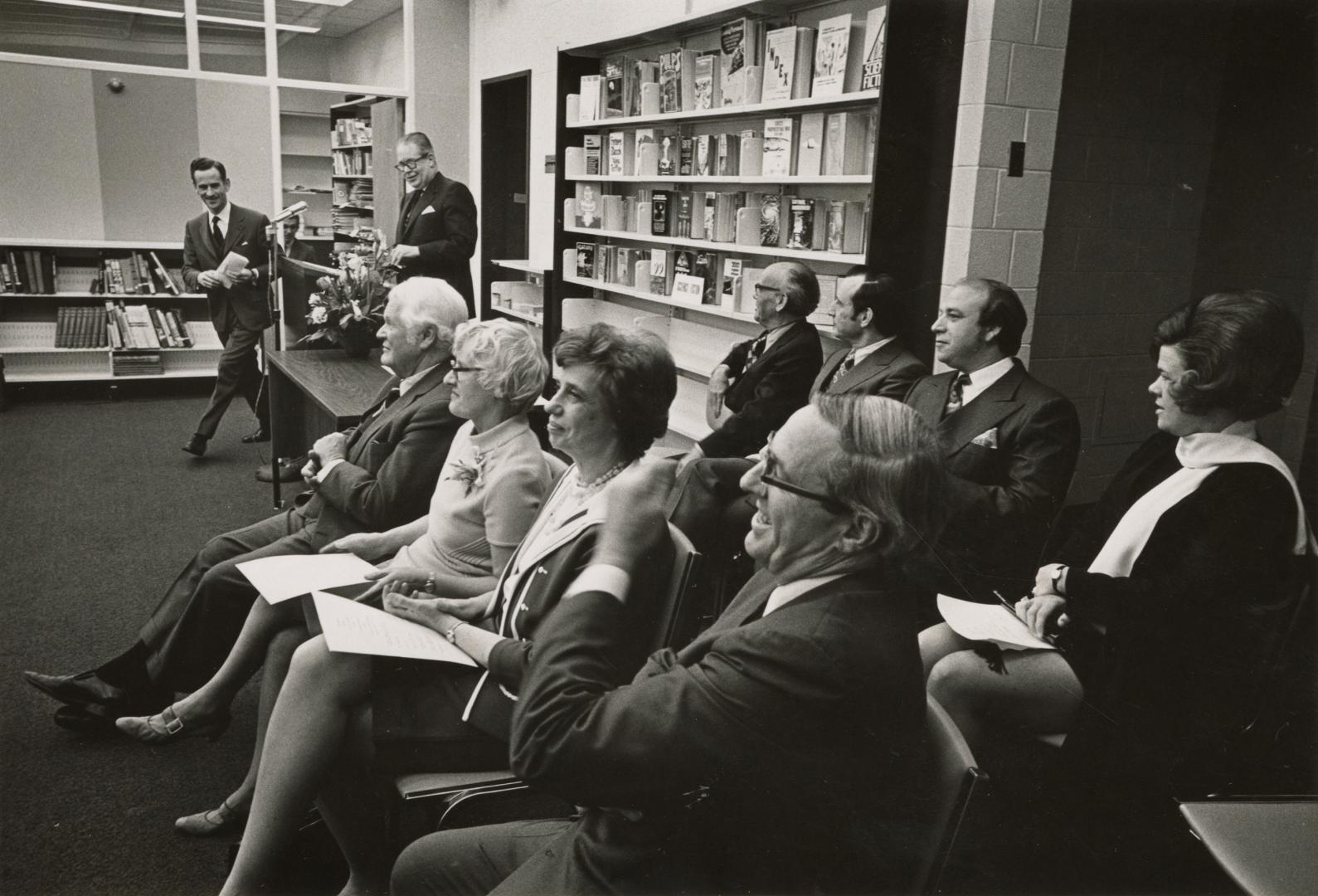 Group of people seated at an official opening. 