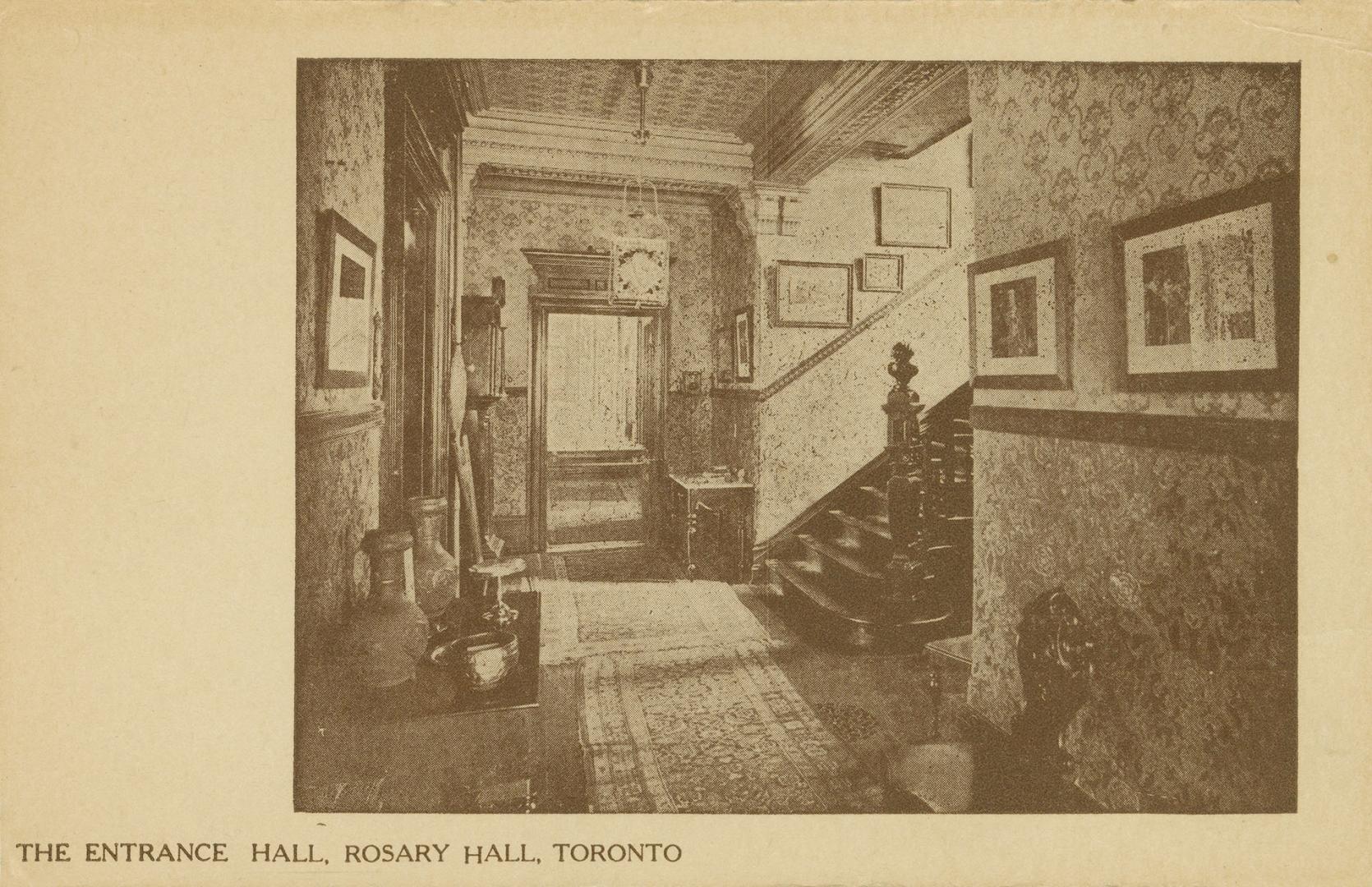 Sepia photo postcard depicting an inset photo of the entrance hall of a women's hostel, decorat ...