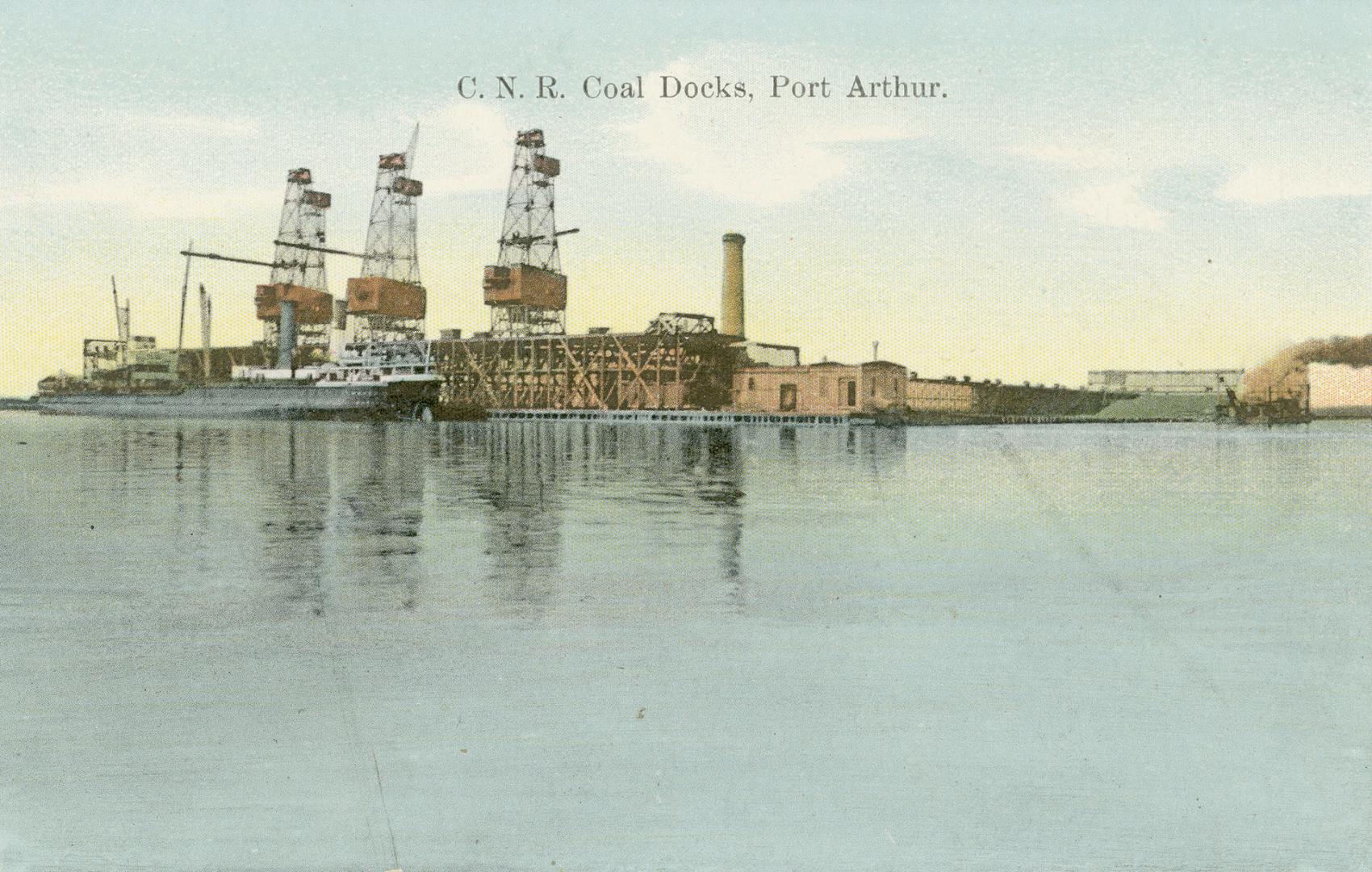 Colorized photograph of three headframes beside docks next to a large body of water.