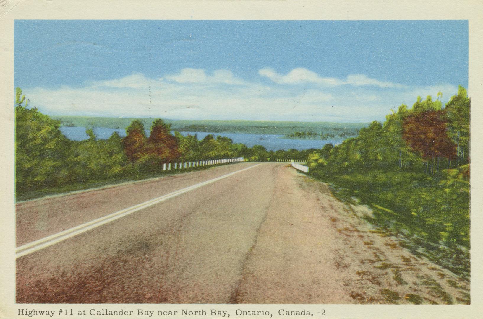 Colorized photograph of a two lane highway running through bush and water.