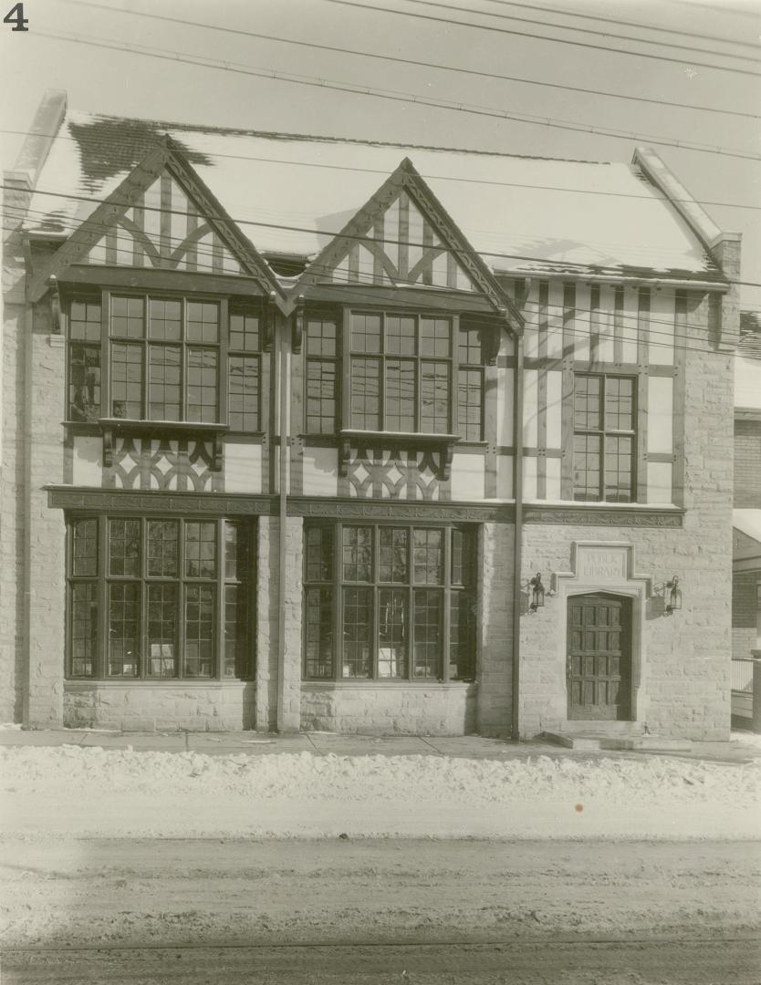 Picture of two storey library and snow on street. 