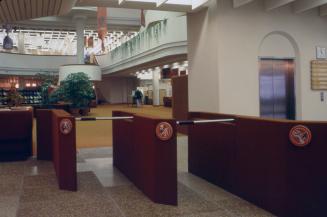 Picture of interior entrance to large library showing turnstiles. 
