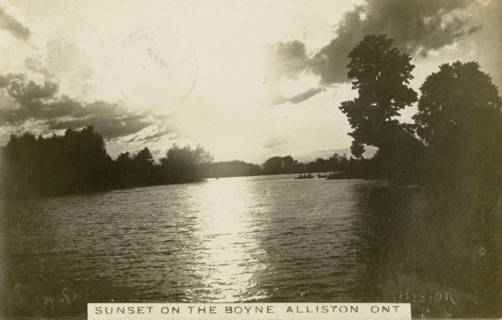 Black and white photograph of a wide body of water surrounded by trees.