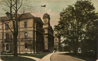 Colorized photograph of a large, three story, white stone, Victorian building with a cupola tow ...