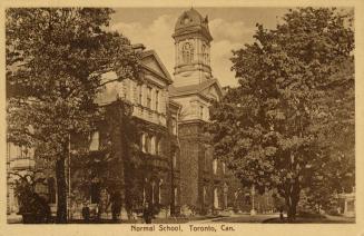 Sepia toned photograph of a large, three story, white stone, Victorian building with a cupola t ...