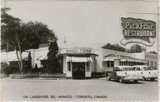 Black and white photo postcard depicting a restaurant with a rooftop sign stating, "PickFair Re ...